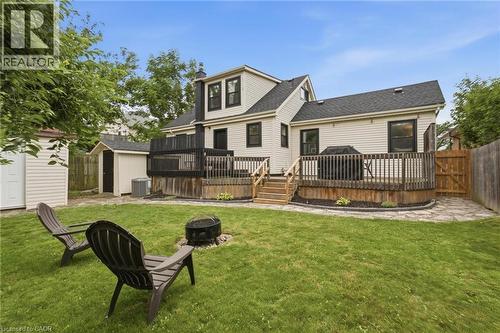 Expansive backyard featuring a wood privacy fence, stone pathway, and a multi-level wooden deck with steps - 481 Upper Gage Avenue, Hamilton, ON - Outdoor With Deck Patio Veranda