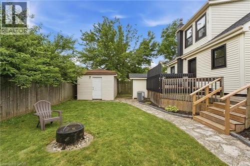 Expansive backyard featuring a wood privacy fence, stone pathway, and a multi-level wooden deck with steps - 481 Upper Gage Avenue, Hamilton, ON - Outdoor