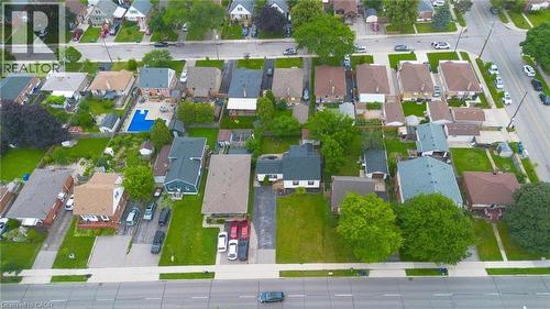 Aerial perspective highlighting a residential neighbourhood with diverse architectural styles, mature trees, and paved roadways - 481 Upper Gage Avenue, Hamilton, ON -  With View