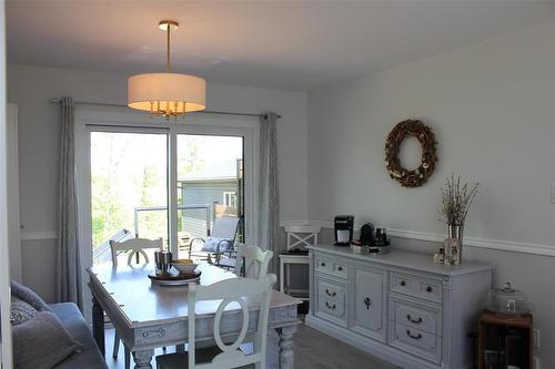 Sliding doors off to the deck from the dining area. - 7 Dalvik Road, Gimli Rm, MB - Indoor Photo Showing Dining Room