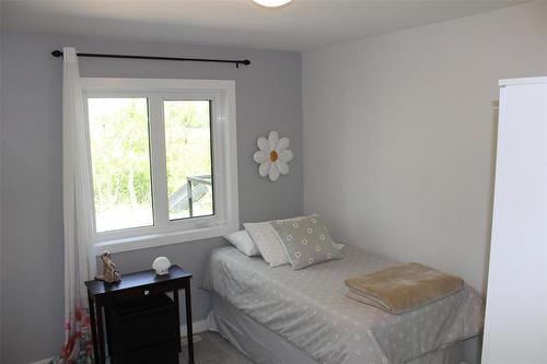 Spare bedroom is spacious and has a lovely view of all the trees in the backyard. - 7 Dalvik Road, Gimli Rm, MB - Indoor Photo Showing Bedroom