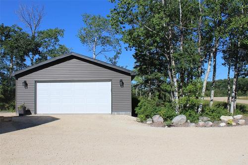 Double car garage has "smart" garage door opener. No more brushing snow off the cars! - 7 Dalvik Road, Gimli Rm, MB - Outdoor