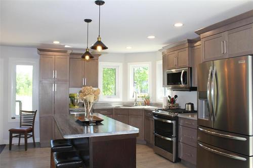 Another view of the kitchen with large island and beautiful window for lot's of natural light. - 7 Dalvik Road, Gimli Rm, MB - Indoor Photo Showing Kitchen With Stainless Steel Kitchen With Upgraded Kitchen