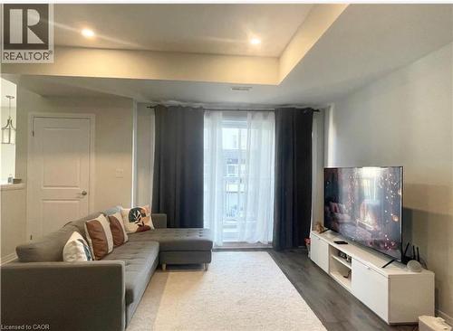 Recessed lighting, wood-finish flooring, and a white built-in media console - 17 Visionary Avenue, Kitchener, ON - Indoor