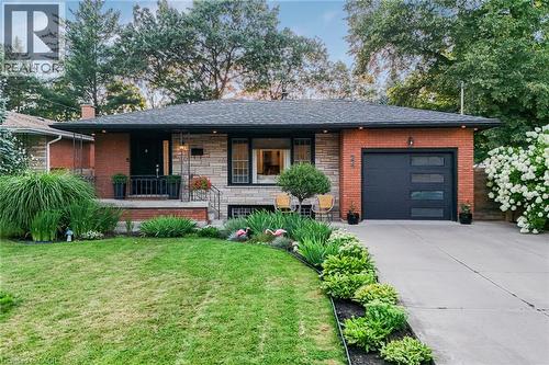 Brick and stone exterior with a dark asphalt shingle roof - 24 Garvey Crescent, Hamilton, ON - Outdoor With Deck Patio Veranda