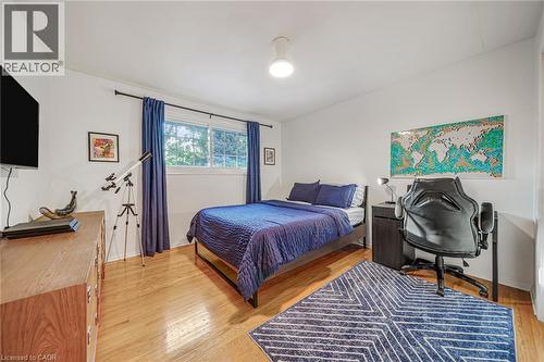 Hardwood flooring, white walls, and a window with natural light - 24 Garvey Crescent, Hamilton, ON - Indoor Photo Showing Bedroom