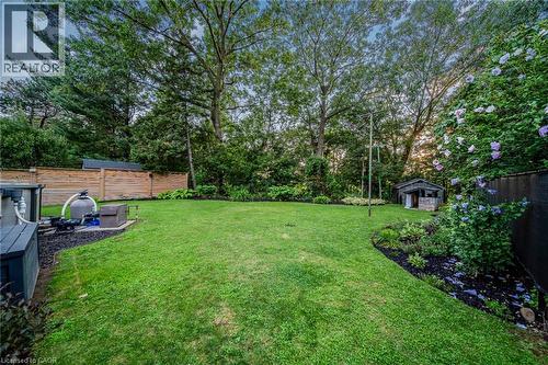 Expansive lawn with mature trees, established perimeter landscaping, wood fencing, and a garden shed - 24 Garvey Crescent, Hamilton, ON - Outdoor