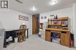 Carpeted room with recessed lighting and a solid wood door - 
