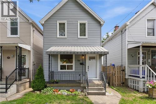 Gabled two-story facade with light gray siding - 56 Harmony Avenue, Hamilton, ON - Outdoor With Deck Patio Veranda