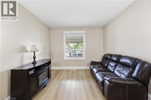 Neutral-toned walls complement wood-finish flooring - 56 Harmony Avenue, Hamilton, ON - Indoor Photo Showing Living Room