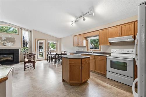 2 Bounty Bay, Winnipeg, MB - Indoor Photo Showing Kitchen With Fireplace With Double Sink