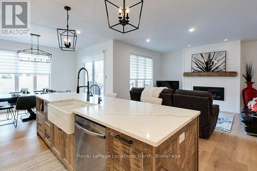 37 Foliage Drive, Tiny, ON - Indoor Photo Showing Dining Room With Fireplace