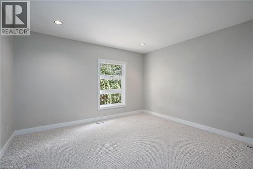 Bright, light-filled bedroom showcasing neutral wall finishes, recessed ceiling lighting, and plush carpeting throughout - 4189 Inglewood Drive, Burlington, ON - Indoor Photo Showing Other Room