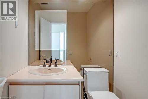 Vanity with integrated sink, bronze-finish faucet, and coordinating mirror - 4189 Inglewood Drive, Burlington, ON - Indoor