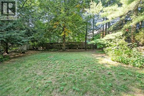 Expansive yard with mature trees and a wood privacy fence - 4189 Inglewood Drive, Burlington, ON - Outdoor