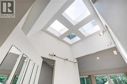 Vaulted ceiling with multiple skylights, integrated track lighting, recessed lighting, and expansive windows - 4189 Inglewood Drive, Burlington, ON - Indoor Photo Showing Other Room
