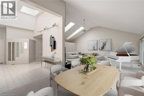 Vaulted ceiling, multiple skylights, track lighting, ceiling fan, and light-toned flooring - 4189 Inglewood Drive, Burlington, ON - Indoor Photo Showing Dining Room