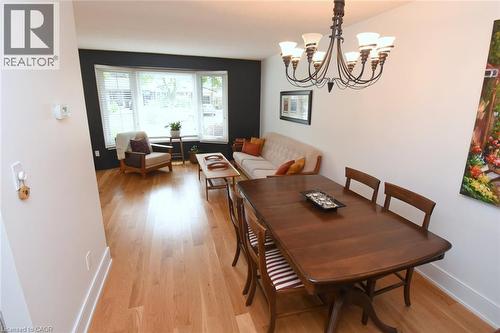 Hardwood flooring throughout, a dining area with a chandelier, and a living area featuring a bay window - 374 Brigadoon Drive, Hamilton, ON - Indoor Photo Showing Dining Room