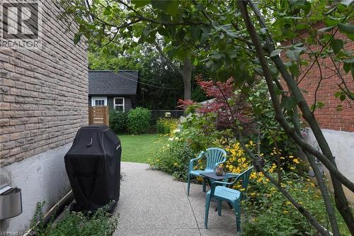 Brick exterior with a gravel pathway and mature landscaping - 374 Brigadoon Drive, Hamilton, ON - Outdoor