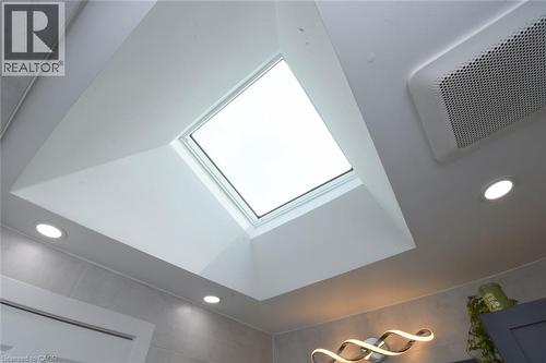 Recessed ceiling lighting, a skylight, and a contemporary wall-mounted light fixture - 374 Brigadoon Drive, Hamilton, ON - Indoor Photo Showing Other Room