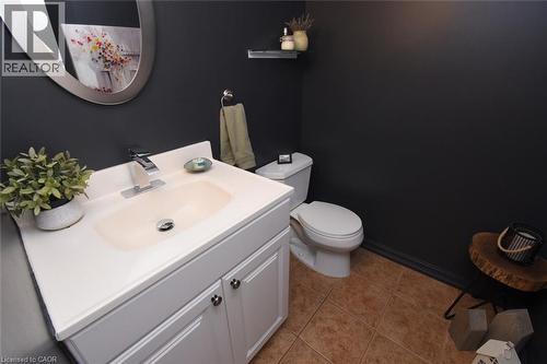 2 piece bathroom, Vanity with integrated sink, chrome faucet, white cabinetry, and tile flooring - 374 Brigadoon Drive, Hamilton, ON - Indoor Photo Showing Bathroom