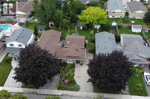 Charming single-story residence showcasing a professionally landscaped front yard featuring two mature specimen trees with full canopies, manicured lawn, and defined hardscape walkway - 374 Brigadoon Drive, Hamilton, ON - Outdoor With View