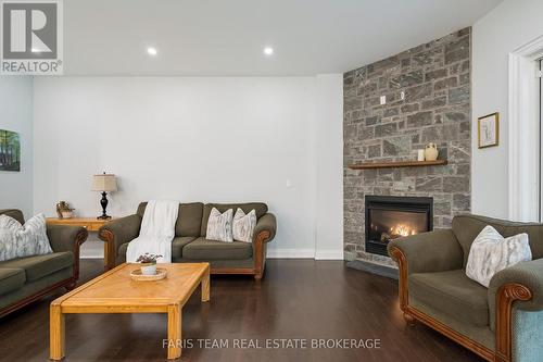 34 Oakwood Avenue, Tiny, ON - Indoor Photo Showing Living Room With Fireplace