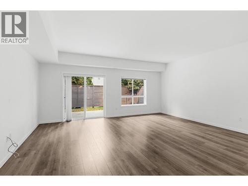 Main floor living room  with walk out access to private back yard space - 680 Old Meadows Road Unit# 74, Kelowna, BC - Indoor Photo Showing Living Room