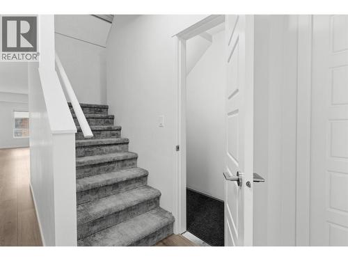 Front entrance foyer with spacious storage closet and staircase to 2nd floor - 680 Old Meadows Road Unit# 74, Kelowna, BC - Indoor Photo Showing Other Room