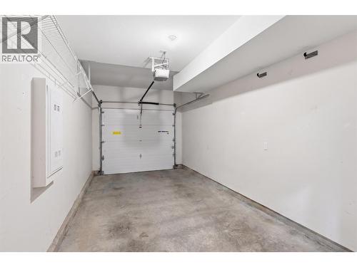 Single car garage (personal items/contents have been digitally removed from this photo) - 680 Old Meadows Road Unit# 74, Kelowna, BC - Indoor Photo Showing Garage
