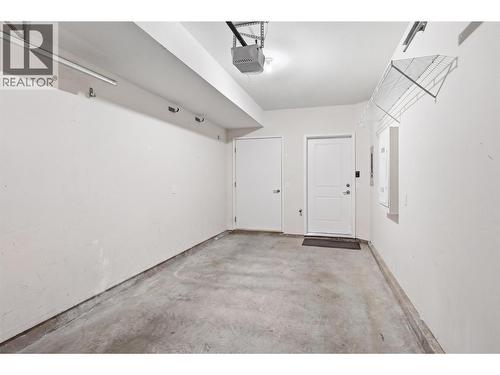 Attached single car garage - (personal contents have been digitally removed from this photo) - 680 Old Meadows Road Unit# 74, Kelowna, BC - Indoor