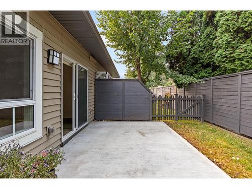 Back patio with fully enclosed fenced back yard - 680 Old Meadows Road Unit# 74, Kelowna, BC - Outdoor With Exterior
