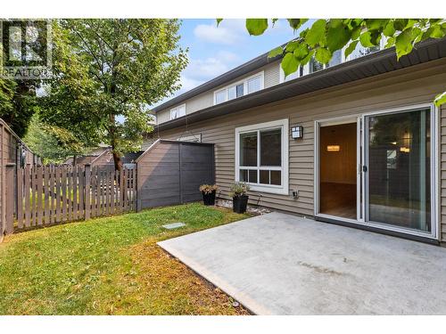 Back patio with fully enclosed fenced back yard - 680 Old Meadows Road Unit# 74, Kelowna, BC - Outdoor With Exterior