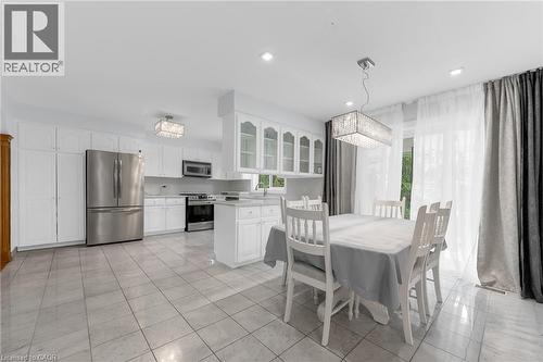 Spacious kitchen featuring white cabinetry, stainless steel appliances, recessed lighting, and tile flooring - 35 Glen Park Court, Hamilton, ON - Indoor
