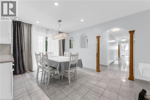 Recessed lighting, tile flooring, archway with wood columns, built-in wall niche, and chandelier lighting fixture - 35 Glen Park Court, Hamilton, ON - Indoor Photo Showing Dining Room