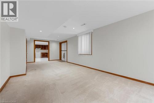 Recessed lighting, light-toned carpet, and wood trim accents - 35 Glen Park Court, Hamilton, ON - Indoor Photo Showing Other Room