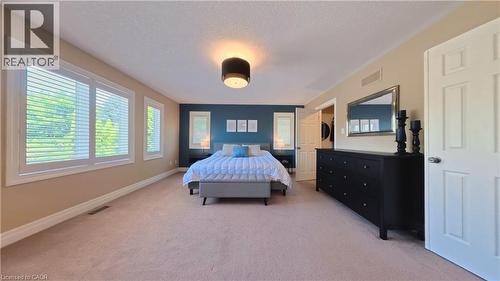 Recessed lighting, soft neutral carpeting, and a contrasting accent wall - 913 Valebrook Court, Kitchener, ON - Indoor Photo Showing Bedroom