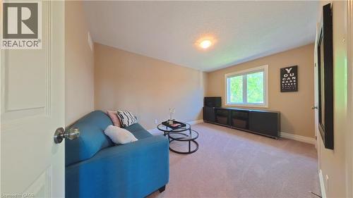 Spacious bonus room featuring neutral carpet flooring, recessed ceiling lighting, and large windows with natural light - 913 Valebrook Court, Kitchener, ON - Indoor