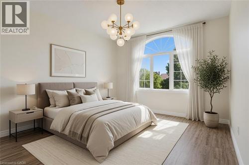 Bright primary bedroom featuring large multi-pane windows with natural light, wood-finish flooring, a neutral color palette with layered bedding, brass pendant lighting fixture, and potted greenery ac - 43 Decaro Crescent, Cambridge, ON - Indoor Photo Showing Bedroom
