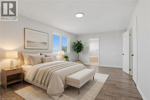 Serene primary bedroom featuring warm wood-finish flooring, recessed ceiling lighting, and abundant natural light from multiple windows - 43 Decaro Crescent, Cambridge, ON - Indoor Photo Showing Bedroom