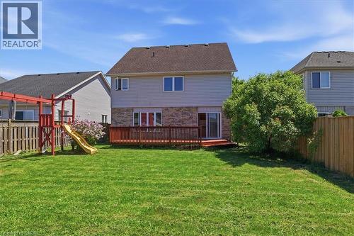 Expansive backyard with a manicured lawn, wood fencing, and a built-in wood deck - 43 Decaro Crescent, Cambridge, ON - Outdoor With Deck Patio Veranda