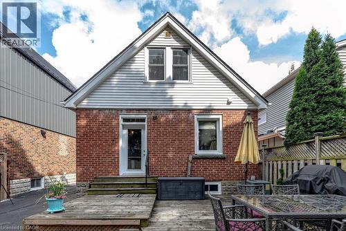Charming brick residence featuring a gabled roofline with siding accents, paired windows with white trim, and a covered entry - 23 Kipling Road, Hamilton, ON - Outdoor