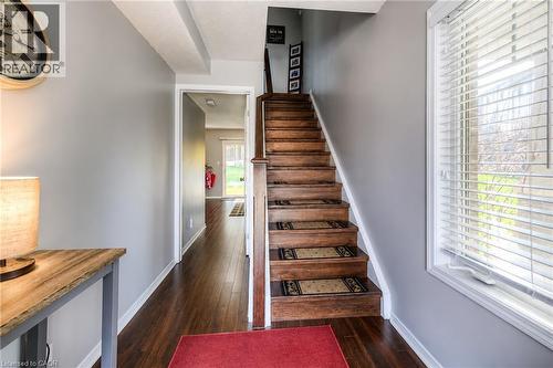 Wood-finish flooring throughout, with a window featuring horizontal blinds, and a wooden staircase - 750 Lawrence Street Unit# 86, Cambridge, ON - Indoor Photo Showing Other Room