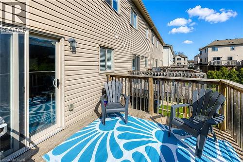 Exterior wood deck with a sliding glass door and tan horizontal siding - 750 Lawrence Street Unit# 86, Cambridge, ON - Outdoor With Deck Patio Veranda With Exterior
