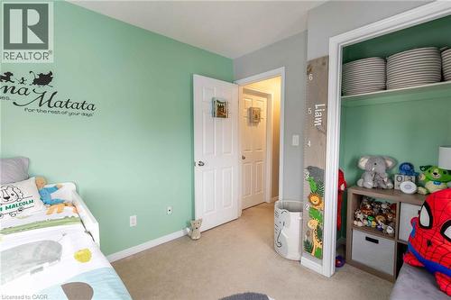 Carpeted flooring, painted walls, white trim, and a built-in closet with shelving - 750 Lawrence Street Unit# 86, Cambridge, ON - Indoor Photo Showing Bedroom