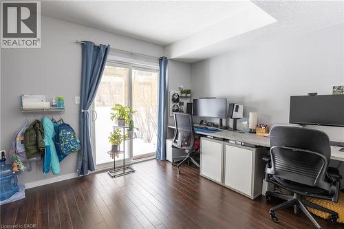 Wood-finish flooring, light gray wall paint, and a sliding glass door - 750 Lawrence Street Unit# 86, Cambridge, ON - Indoor Photo Showing Office