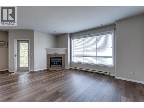 1962 Enterprise Way Unit# 401, Kelowna, BC - Indoor Photo Showing Living Room With Fireplace