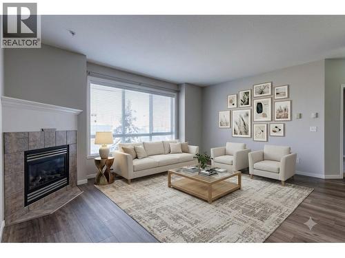 Living Room Virtually Staged - 1962 Enterprise Way Unit# 401, Kelowna, BC - Indoor Photo Showing Living Room With Fireplace