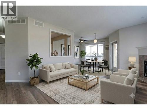 Living Dining Virtually Staged - 1962 Enterprise Way Unit# 401, Kelowna, BC - Indoor Photo Showing Living Room With Fireplace