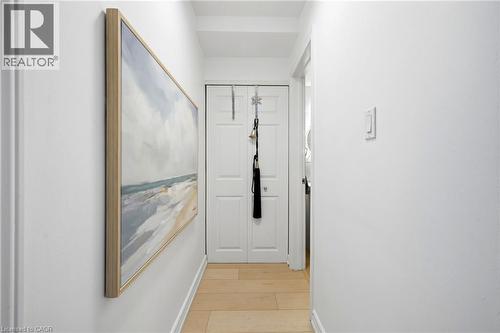 Light wood-finish flooring with white baseboards - 8 Woodman Drive S Unit# 708, Hamilton, ON - Indoor Photo Showing Other Room